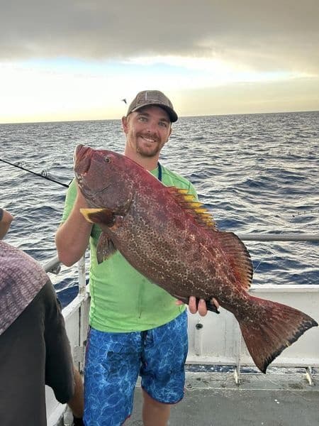 Two anglers at the dock with a redfish