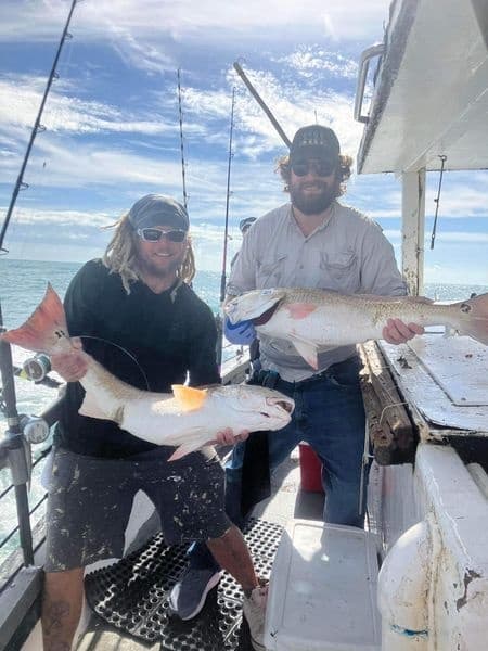An angler on deck with a red snapper