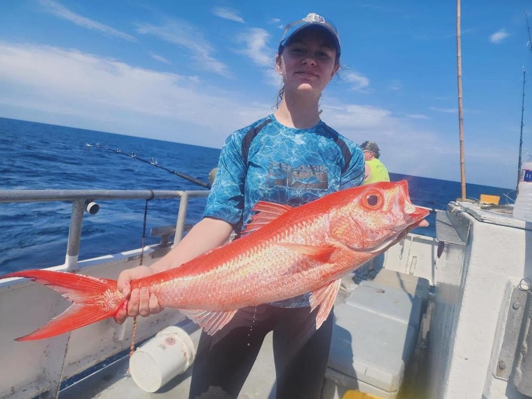 Anglers at the dock with a large snapper